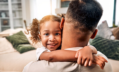 Portrait of a beautiful cute african american cute girl hugging her dad and looking at the camera.