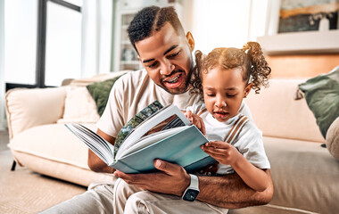 African american happy family dad and daughter studying together. A man talks to a child. A girl examines a book with interest.