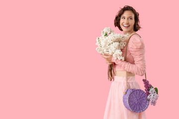 Happy young woman with bouquet of blooming white lilac flowers on pink background