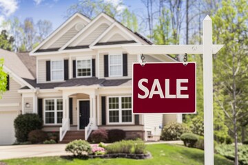 A "For Sale" sign stands beside an American family house in a suburban neighborhood, emblematic of the bustling real estate market.







