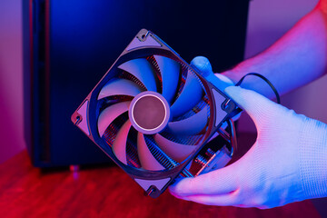 Air cooling system with fan close up. PC case on background in neon light with smoke. Rendering and...