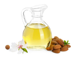 Almond oil in glass jug, fresh nuts and beautiful flower isolated on white