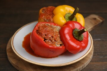 Delicious stuffed bell peppers served on wooden table