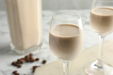 Coffee cream liqueur in glasses on table, closeup