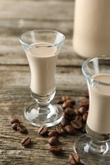 Coffee cream liqueur in glasses and beans on wooden table