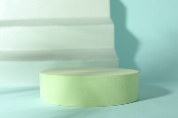 Presentation of product. Podium, paper and shadows on turquoise background. Space for text