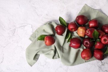 Fresh ripe red apples with leaves on white marble table, flat lay. Space for text