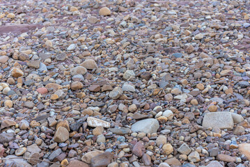 Stones rolled from the river after flooding and torrential rain