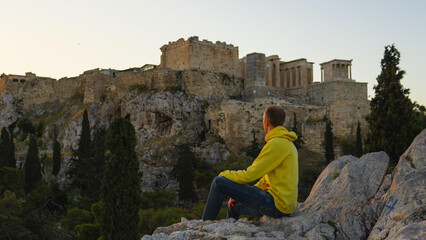 Man on a hill looking at the Acropolis in Athens, Greece