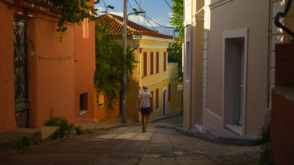 Person walking in a colorful alley in Athens, Greece