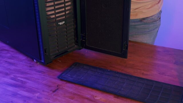 Computer Technician cleaning empty PC case for workstation. Concept of desktop PC maintenance and service.