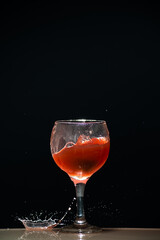 Splashes in a glass cup with guava juice inside.