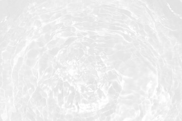 White water with ripples on the surface. Defocus blurred transparent white colored clear calm water surface texture with splashes and bubbles. Water waves with shining pattern texture backgrounds.