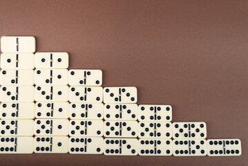 Dominoes on a brown background. White
