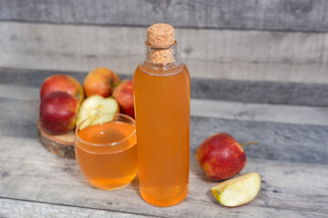 Apple vinegar. Bottle of homemade apple organic vinegar, wine or cider on dark wooden background....