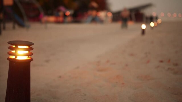 Lighted lantern on background of people walking