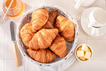 Sweet and homemade french croissants with milk and honey.