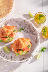 Healthy and homemade french croissant with salmon and avocado