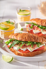 Homemade french croissant made of ham, cheese and vegetables.