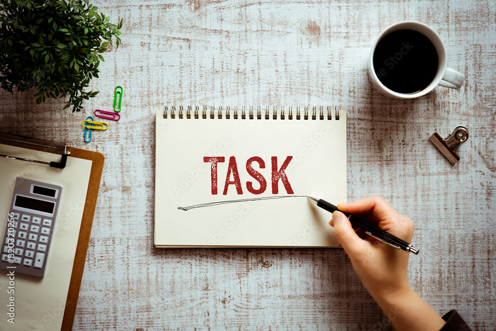 Poster there is notebook with the word task. it is as an eye-catching image.