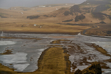Aerial view of valley and frozen lake in Iceland on cloudy day
