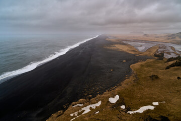 General aerial view of the black beach of Dyrhólaey in Iceland on a cloudy day