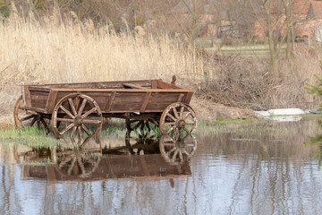 An old wooden cart.A wooden cart in the water.Spring flood.