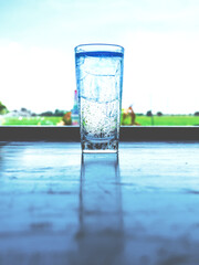 The ice glass was filled with steam and reflected on the table.
