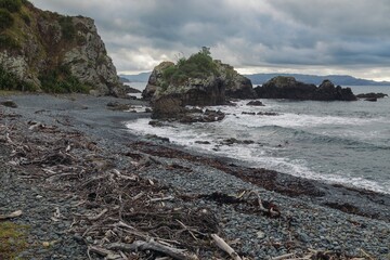 Remote stony beach at sunset. Tawharanui, Matakana, Auckland, New Zealand.