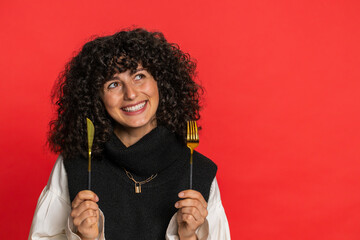 Ready to eat. Hungry Caucasian woman with curly hair waiting for serving dinner dishes with with...