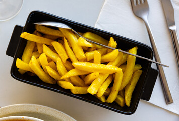 Hearty snack and portion of French fries are served for guests of restaurant. Food is served in...