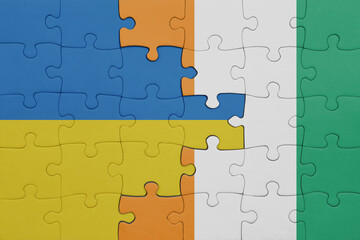 puzzle with the colourful national flag of cote divoire and flag of ukraine.