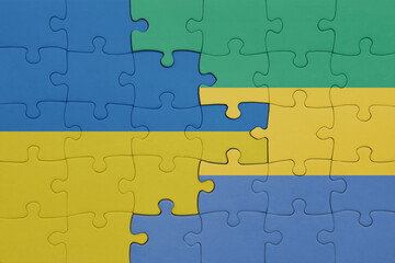 Fototapeta premium puzzle with the colourful national flag of gabon and flag of ukraine.