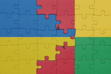 puzzle with the colourful national flag of guinea bissau and flag of ukraine.