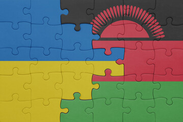 puzzle with the colourful national flag of malawi and flag of ukraine.