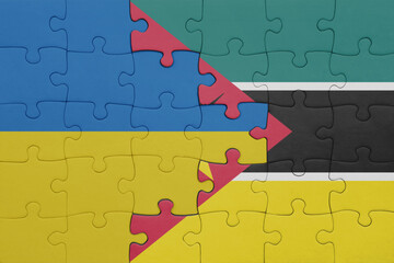 puzzle with the colourful national flag of mozambique and flag of ukraine.