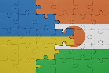 puzzle with the colourful national flag of niger and flag of ukraine.