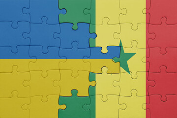 puzzle with the colourful national flag of senegal and flag of ukraine.