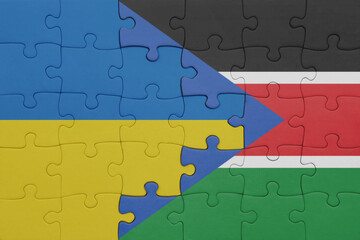 puzzle with the colourful national flag of south sudan and flag of ukraine.