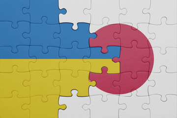 puzzle with the colourful national flag of japan and flag of ukraine.