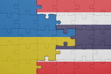 puzzle with the colourful national flag of thailand and flag of ukraine.