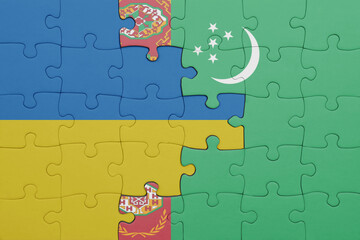 puzzle with the colourful national flag of turkmenistan and flag of ukraine.