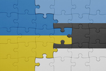 puzzle with the colourful national flag of estonia and flag of ukraine.