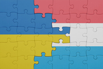 puzzle with the colourful national flag of luxembourg and flag of ukraine.