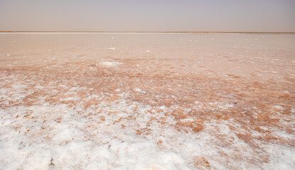 Endless salt flat landscape of Sebkha el Melah in Zarzis, Tunisia, extending to horizon with...