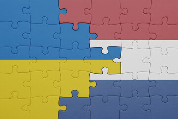 Fototapeta premium puzzle with the colourful national flag of netherlands and flag of ukraine.