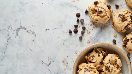 Fresh cookie dough with chocolate chips on marble countertop