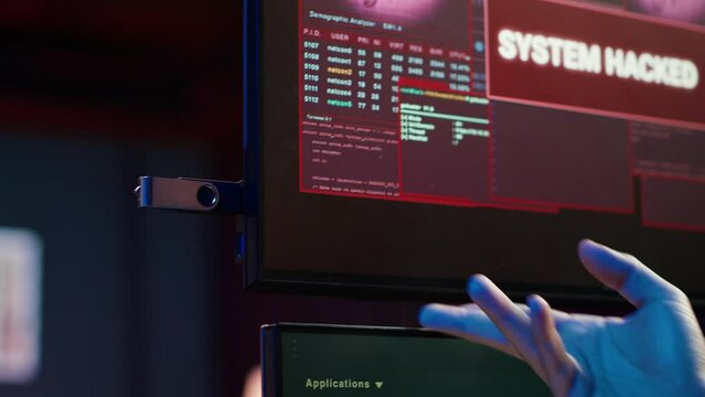 Hacker doing illegal activities in secret underground base, uploading USB flash drive containing data obtained from victim after tricking it into installing ransomware program, camera A