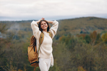 Smiling Woman Embracing Mountain Adventure: A Stylish Journey of Happiness and Freedom