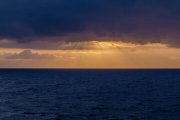 Panoramic view of the cloudy Aegean Sea and a golden  sunrise
